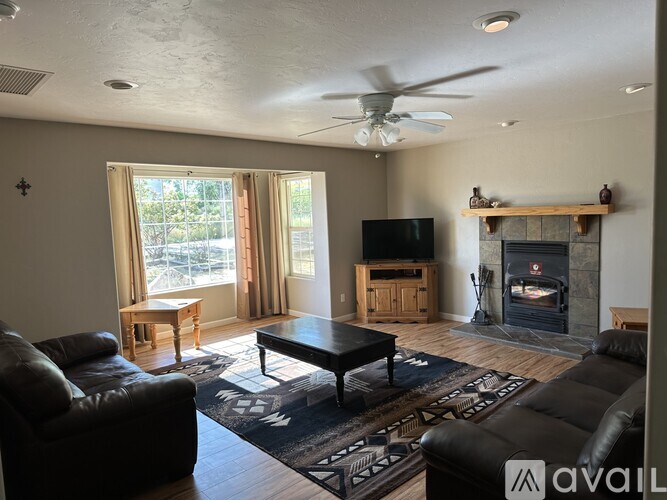 A living room with a fireplace and a television.