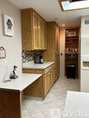 A kitchen with wooden cabinets and a white countertop.