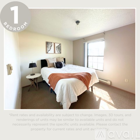 A bedroom with a bed, nightstand, and lamp.