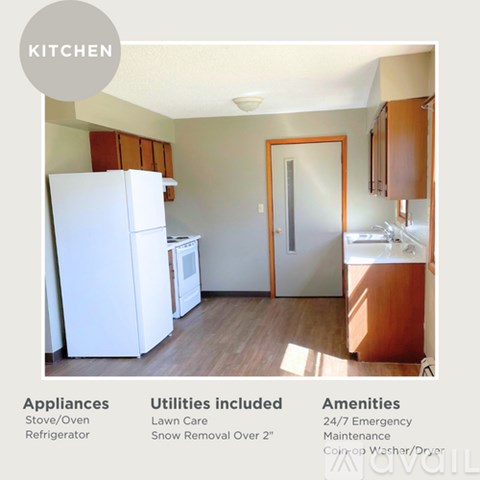 A kitchen with a refrigerator, oven, and microwave.