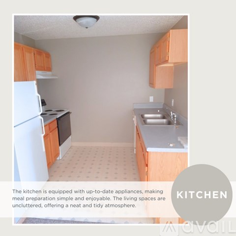 A kitchen with white appliances and wooden cabinets.