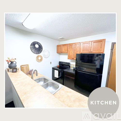 A kitchen with a sink, stove, and cabinets.