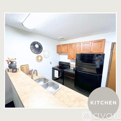A kitchen with a sink, stove, and cabinets.