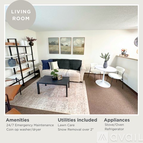 A living room with a couch, chair, and table with a plant on it.