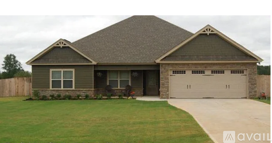 A house with a grey roof and a garage door.