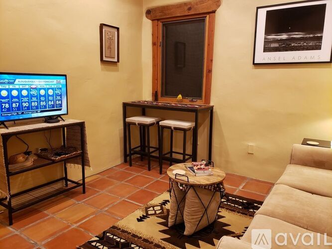 A living room with a TV, a table, and a couch.