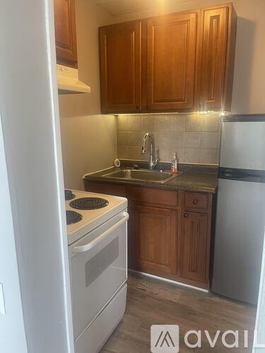 A kitchen with wooden cabinets and a white refrigerator.