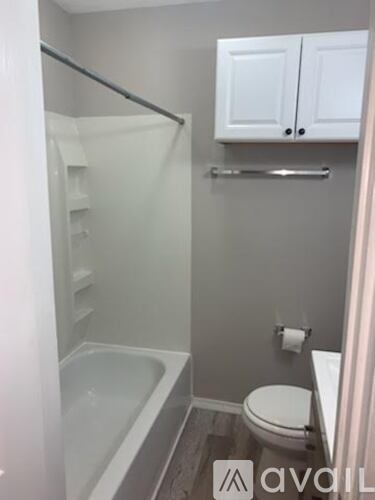 A bathroom with a toilet, sink, and bathtub.