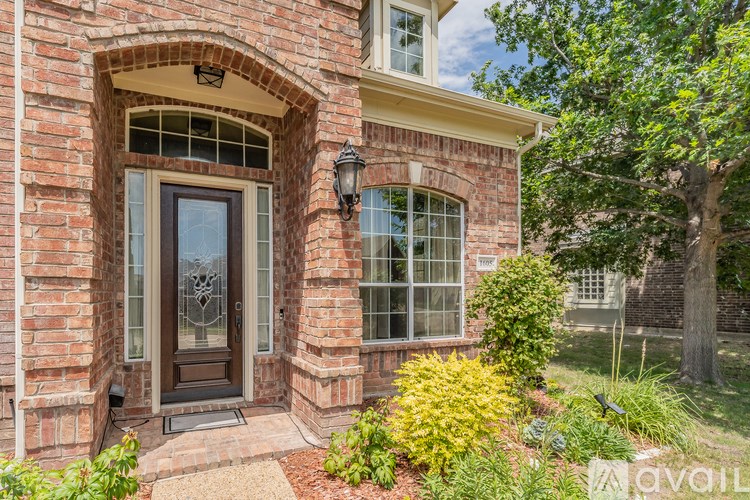 A house with a brick facade and a large arched window.