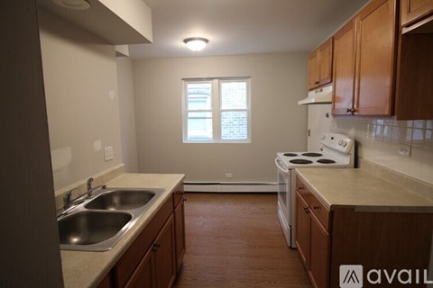 A kitchen with a white stove top oven and a window.