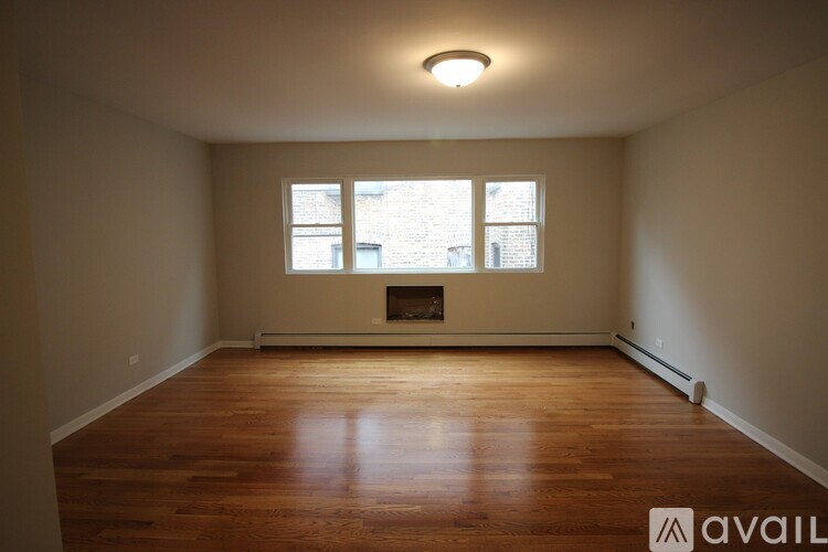 A room with a fireplace and a window.