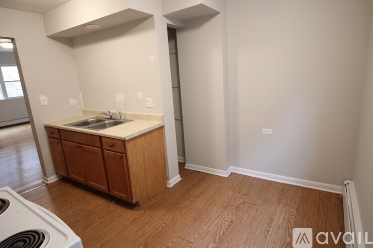 A kitchen area with a sink and cabinets.