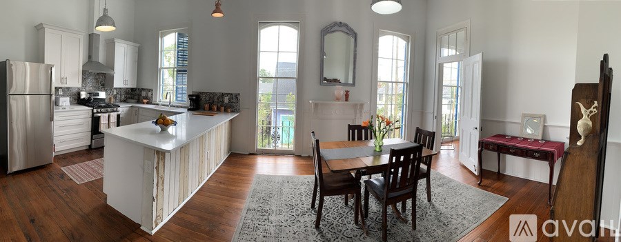 A kitchen with a table and chairs in the middle of the room.