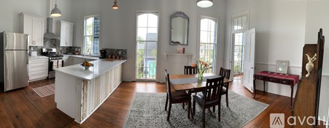 A kitchen with a table and chairs in the middle of the room.