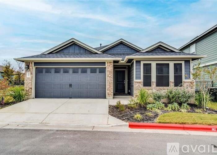 A two-story house with a garage and a driveway.