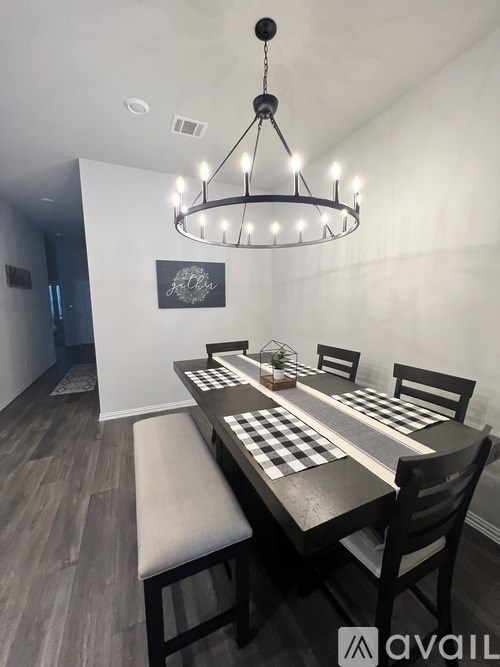 A dining room with a wooden table and chairs.