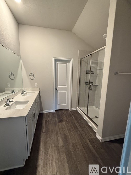 A bedroom with a bed, window, and a painting on the wall.