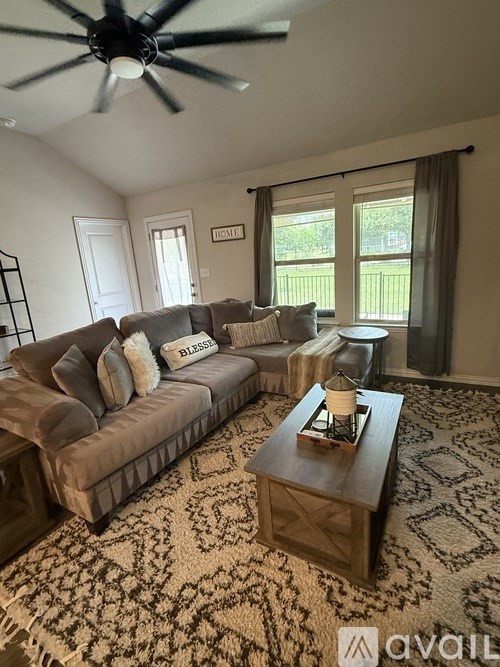 A living room with a grey couch and a wooden coffee table.
