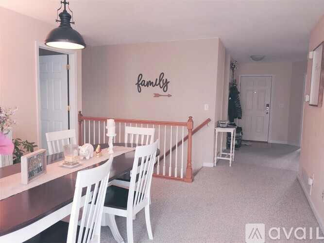 A dining room with a wooden table and chairs.