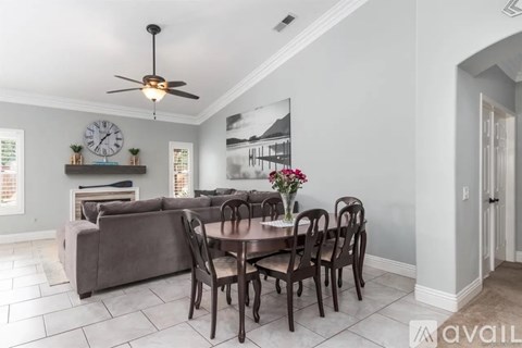 A dining room with a table set for six.