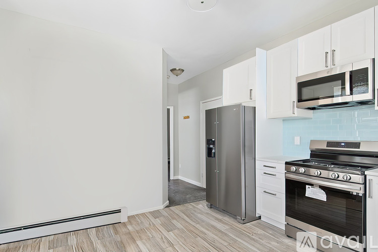 A kitchen with a stove, oven, and cabinets.