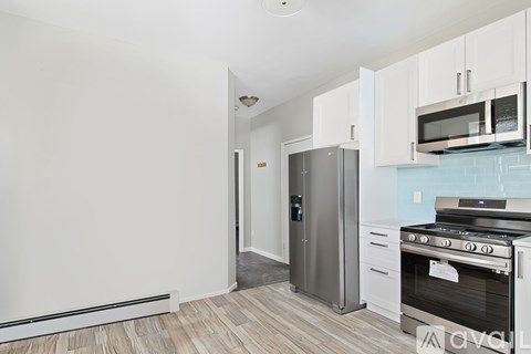 A kitchen with a stove, oven, and cabinets.