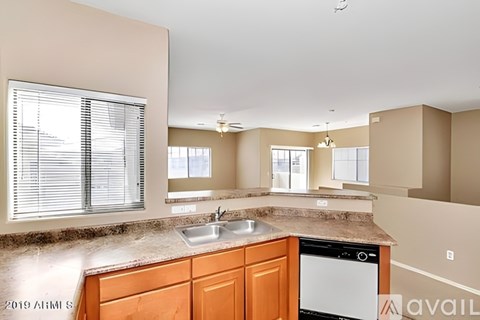 A kitchen with a sink and a dishwasher.
