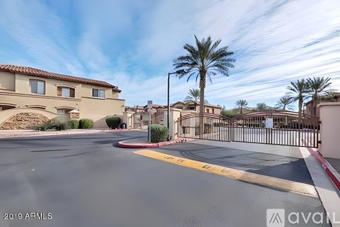 A street view of a residential area with houses and palm trees.