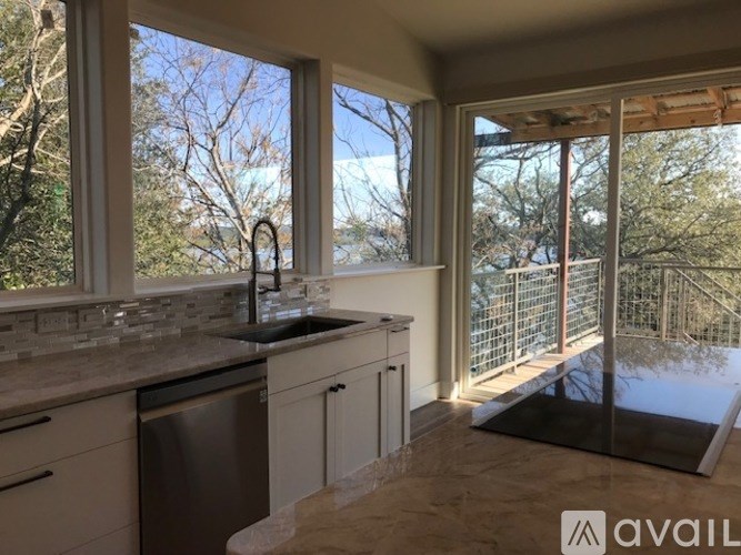 A kitchen with a sink and a window.
