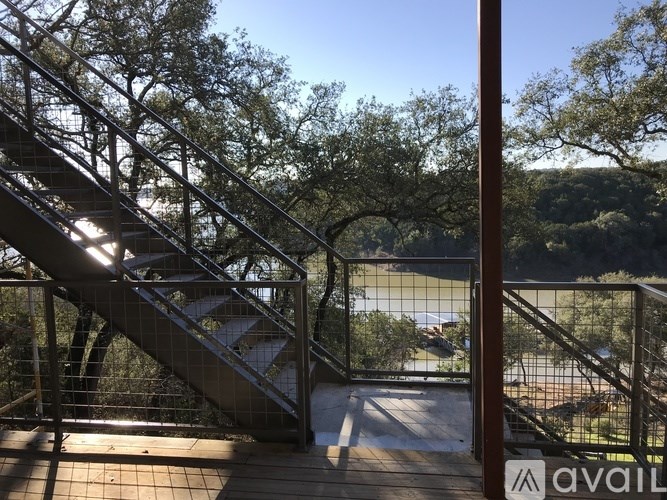 A staircase with a metal railing leads down to a grassy area.