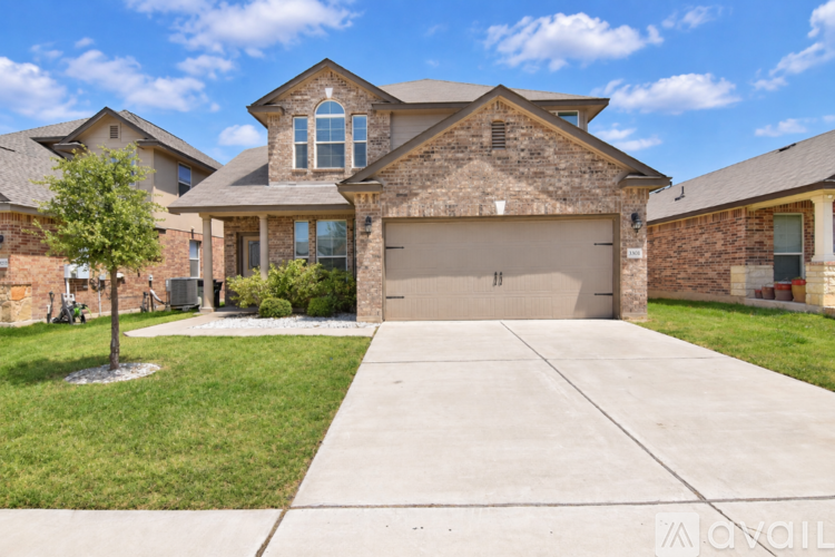 A large house with a driveway in front.