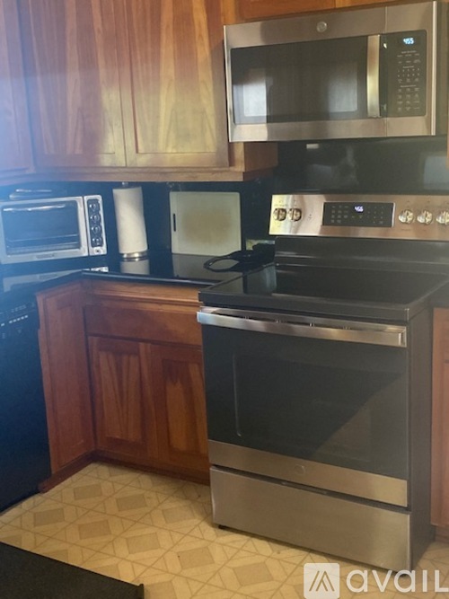 A kitchen with a black oven and a black microwave above it.
