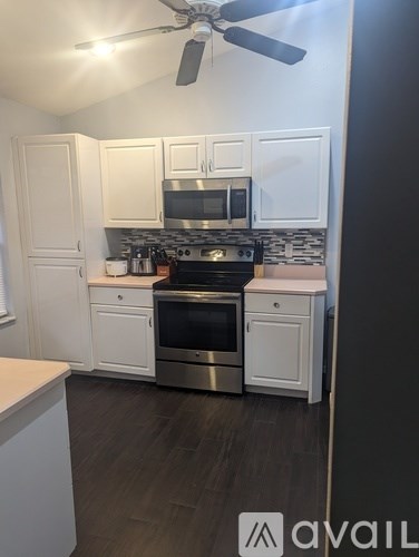 A kitchen with a stove top oven and microwave.