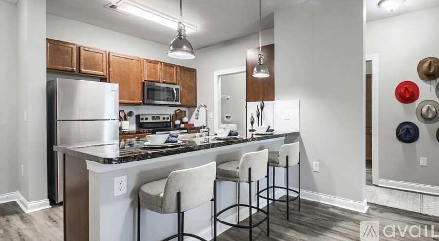 A kitchen with white cabinets and a black countertop.