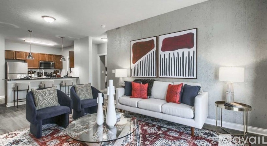 A living room with a white couch and a rug.