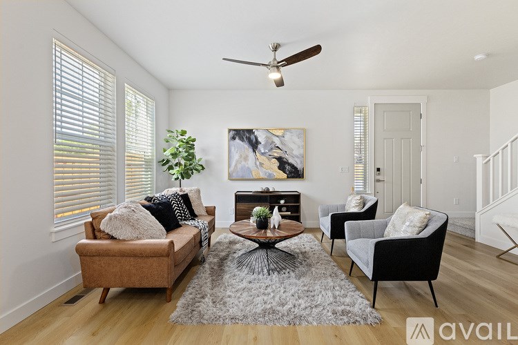 A living room with a brown couch, a coffee table, and a painting on the wall.