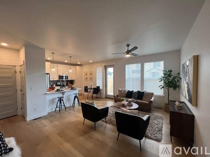 A living room with a black chair and a white table.
