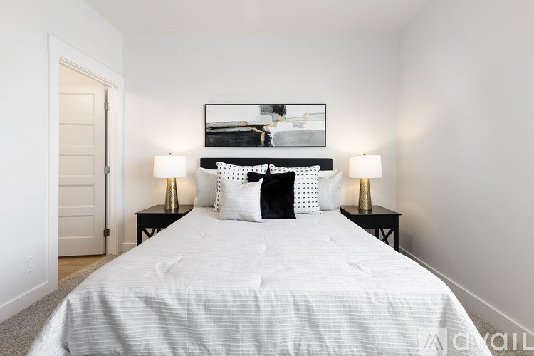 A bedroom with a large bed and a mirror above it.