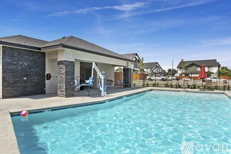 A swimming pool in front of a house with a sign that says "available".