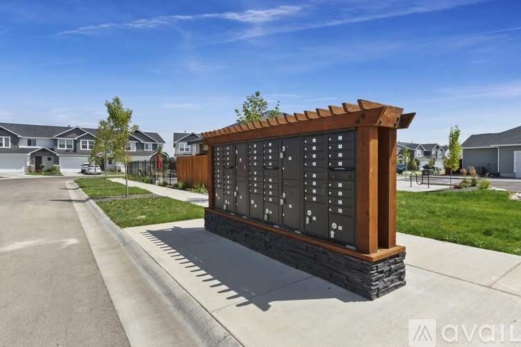 A wooden sign with black numbers stands in front of a row of houses.