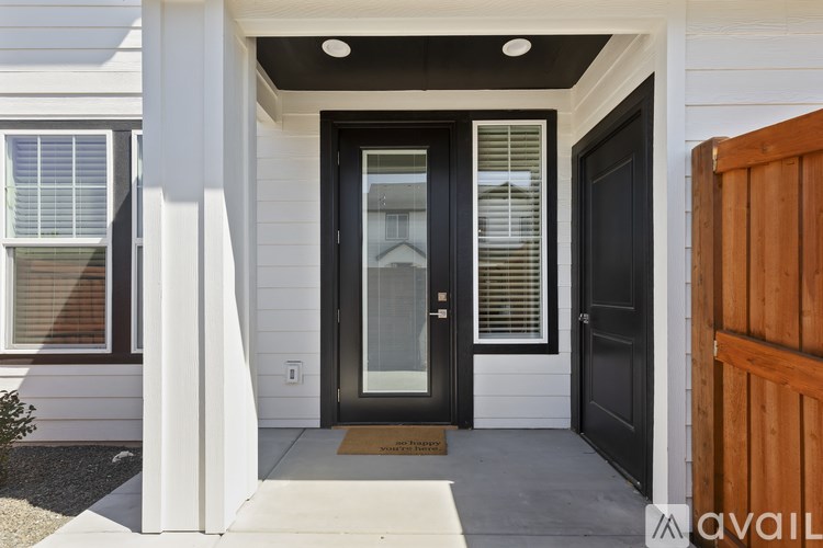 A black door with a glass window is on the right side of the frame.