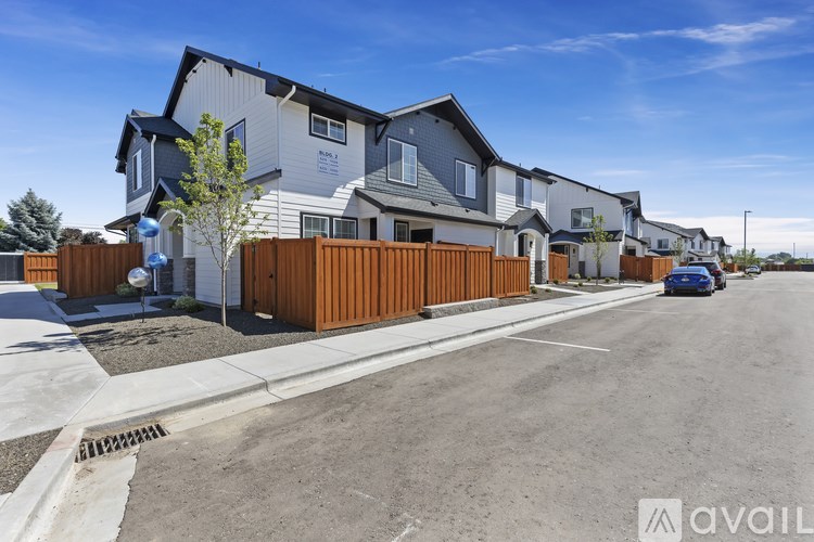 A row of houses with a car parked on the street.