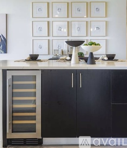 A kitchen with black cabinets and a white countertop.