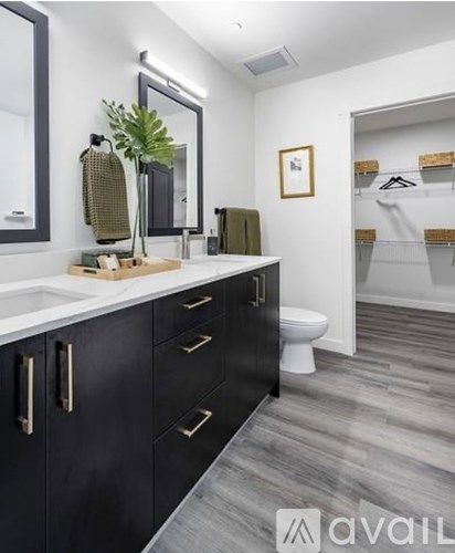 A bathroom with black cabinets and a white countertop.