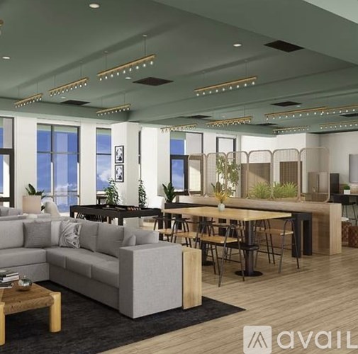 A modern living room with a grey sofa, wooden coffee table, and a dining table with chairs.