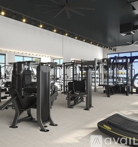 A gym with various exercise machines and a treadmill.