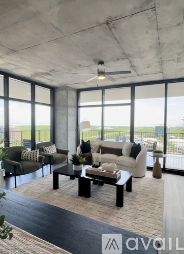 A living room with a large window and a view of the outside.
