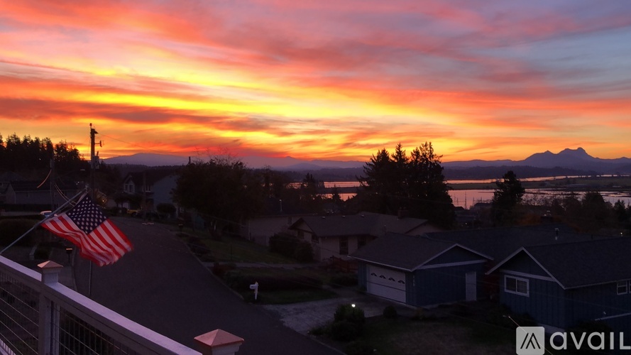 A beautiful sunset view from a balcony with an American flag.