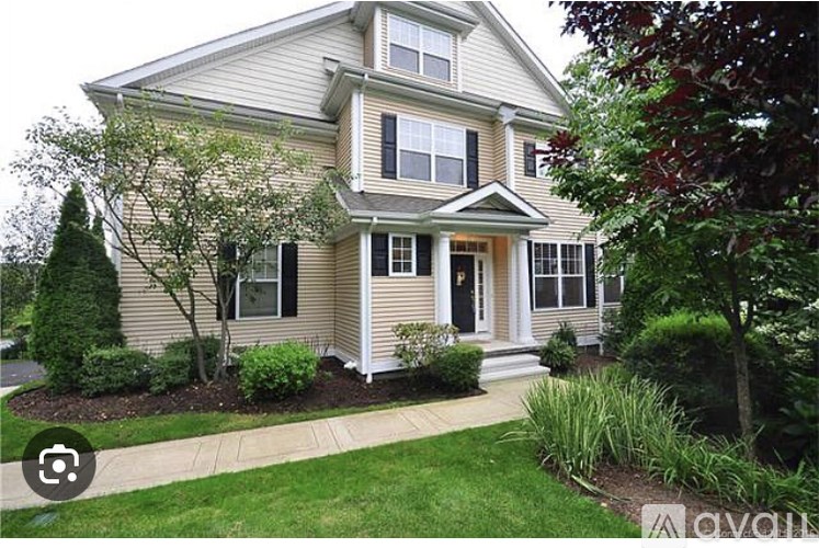 A house with a well-maintained lawn and landscaping.