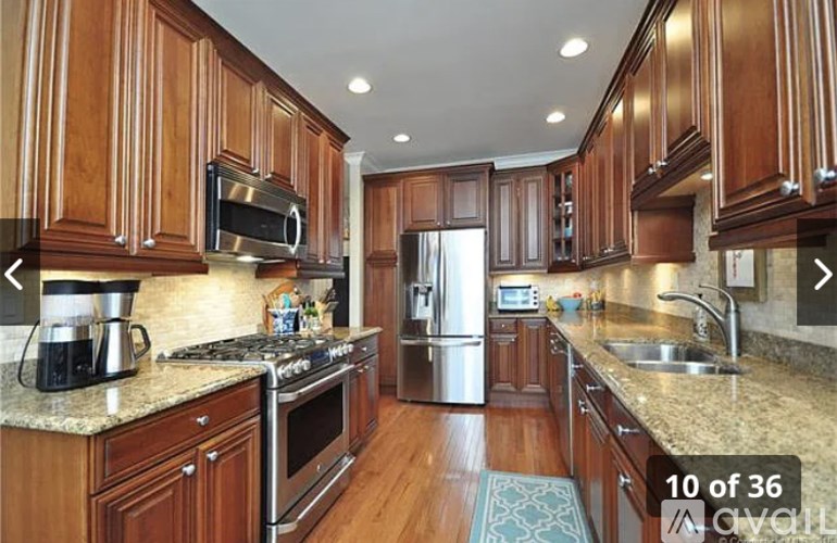 A kitchen with wooden cabinets and granite countertops.